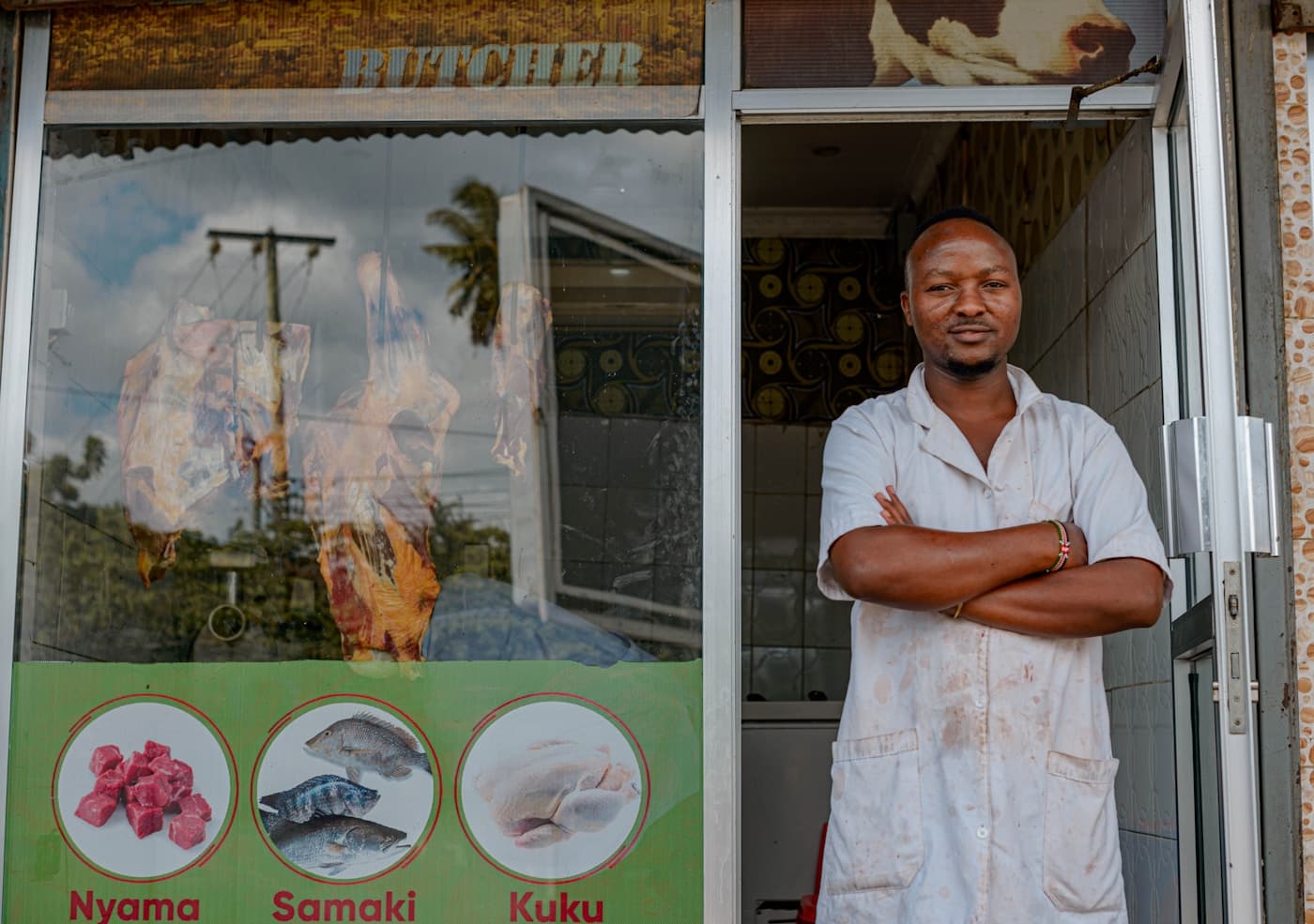 Kenyan shop owner outside his butchery - commercial insurance from Mufasa Insurance